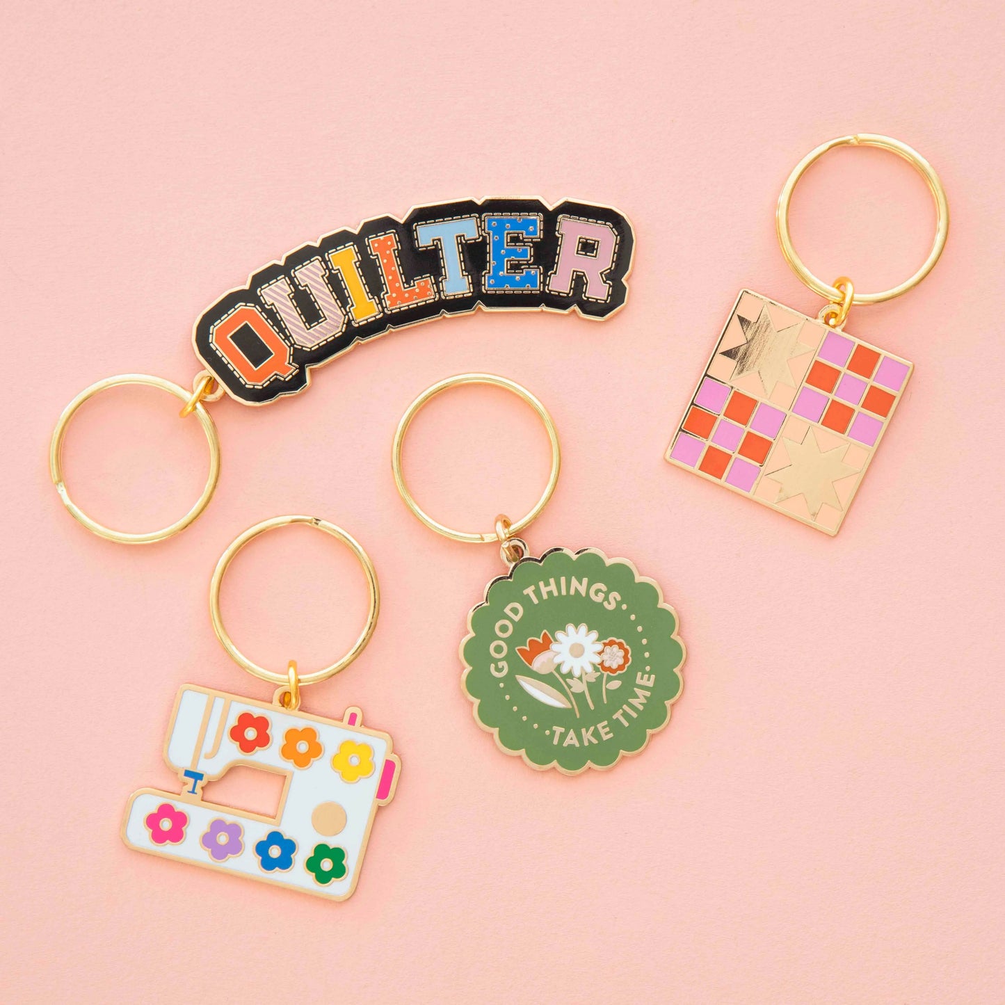 Collection of colorful keychains on a pink background