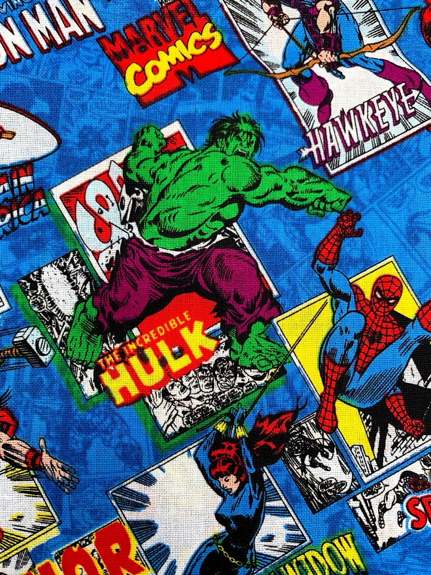 Marvel Comics fabric with superhero characters and logos on a blue background