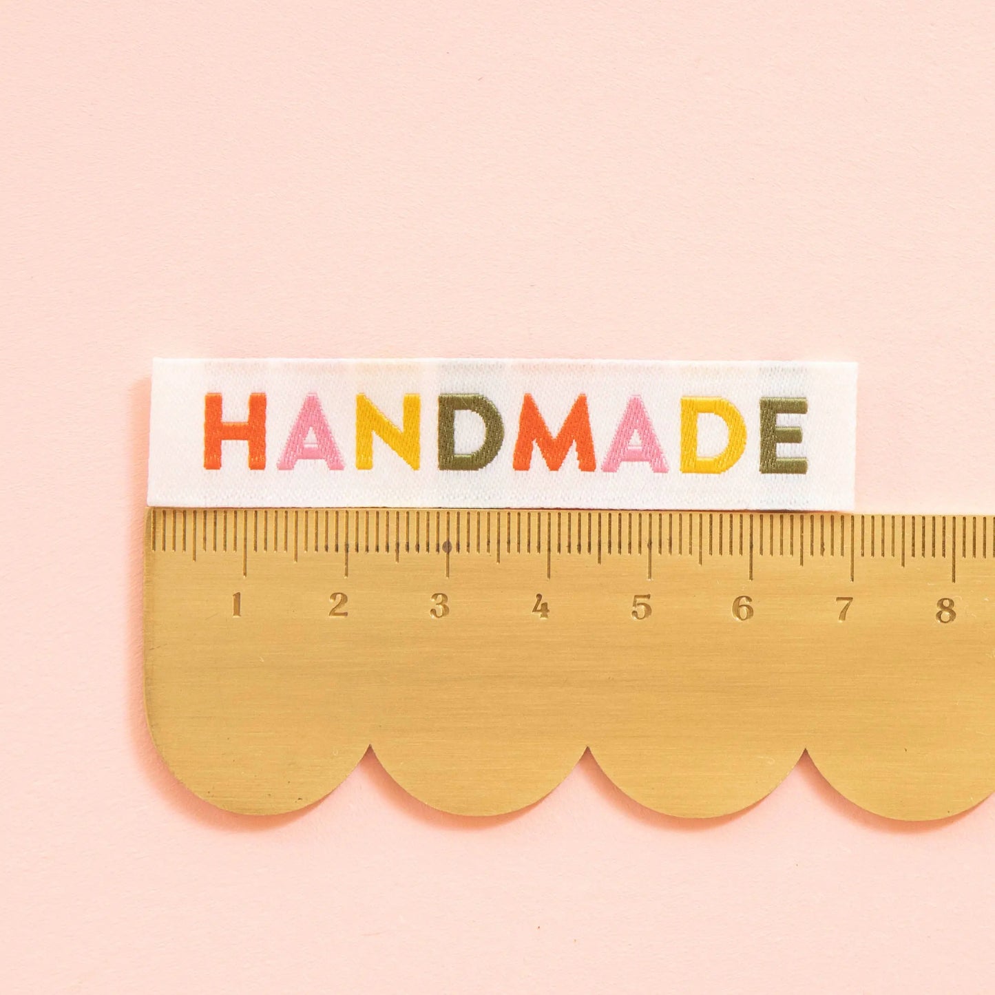 Ruler with 'HANDMADE' text on a pink background