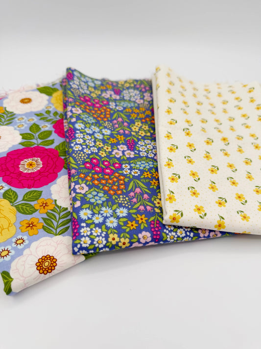 Three pieces of floral fabric on a white background