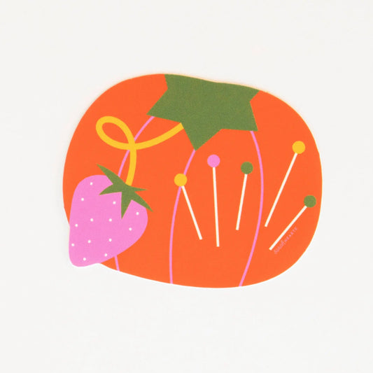 Colorful sewing sticker illustration of a tomato pin cushion and strawberry on a white background