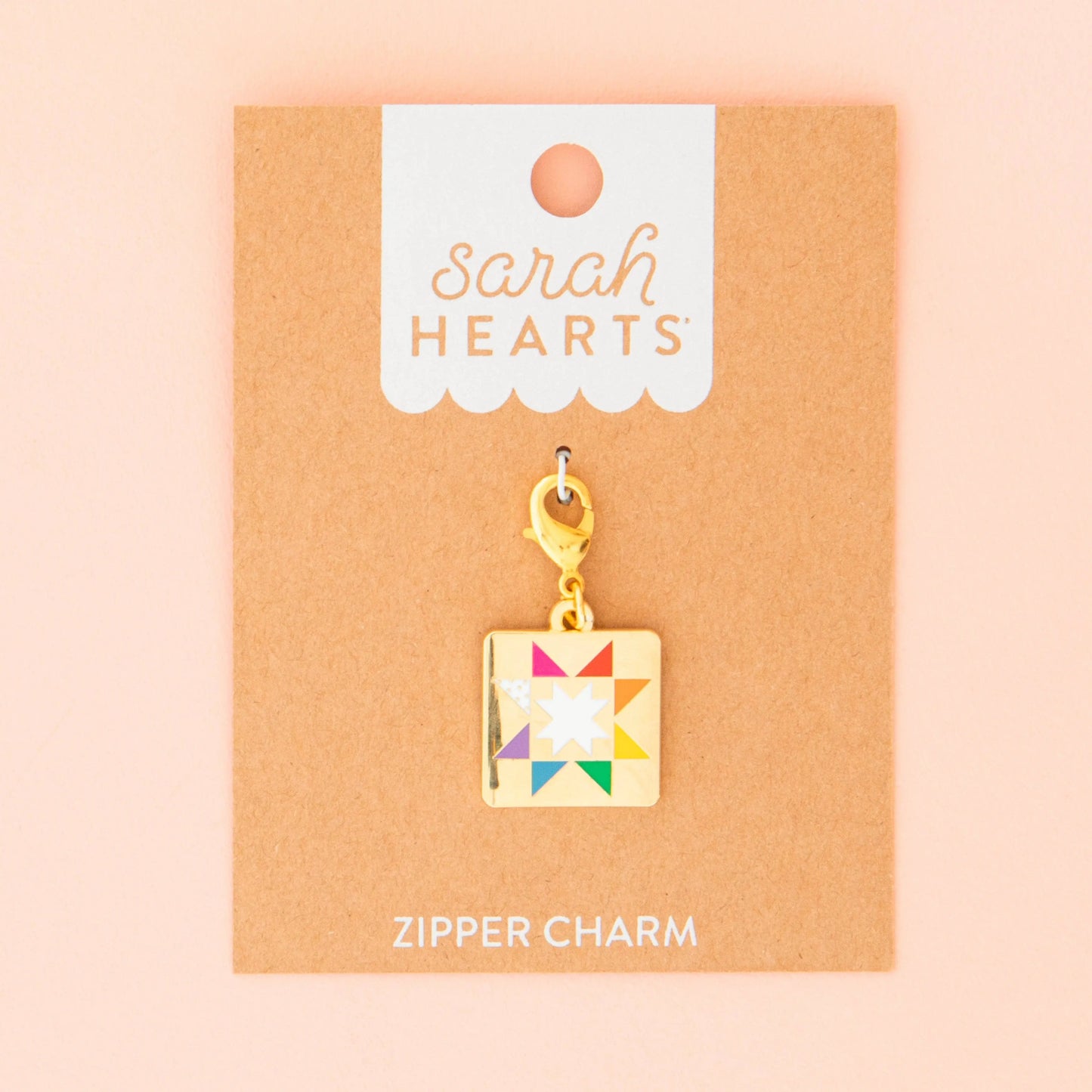 Colorful quilt zipper pull charm on a 'Sarah Hearts' branded card with a pink background