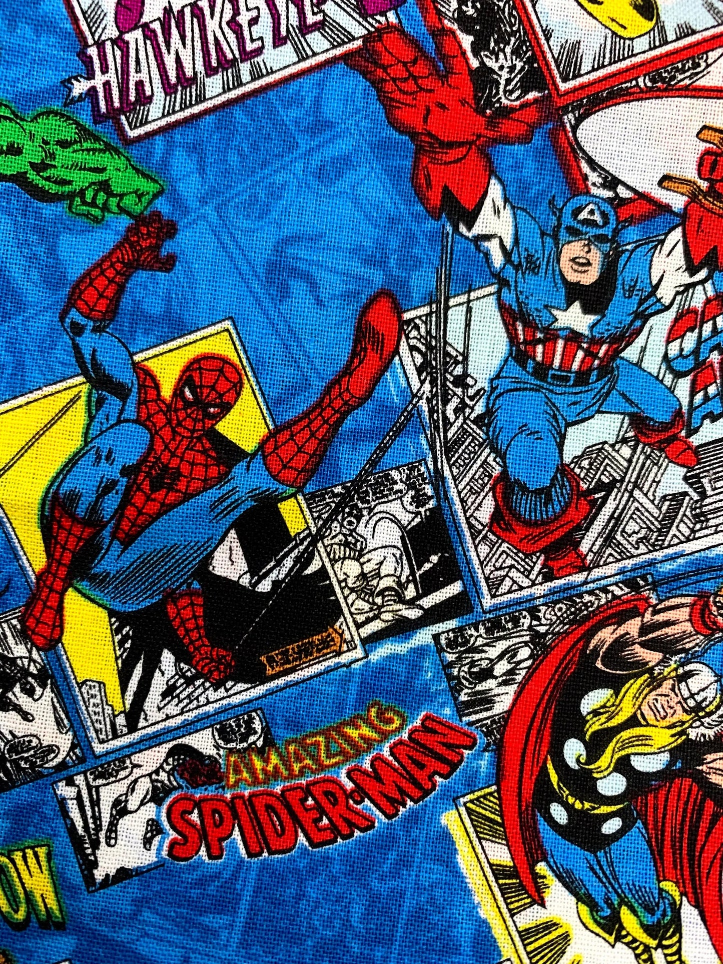 Comic book-style fabric with superhero characters including Spider-Man and Captain America.