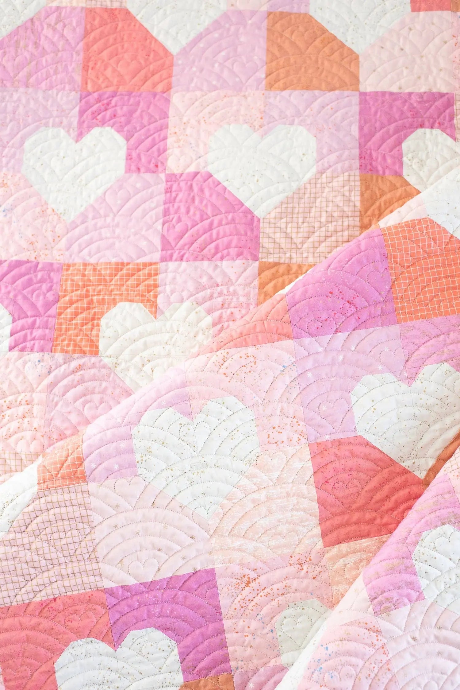 Quilt with heart patterns in pastel colors