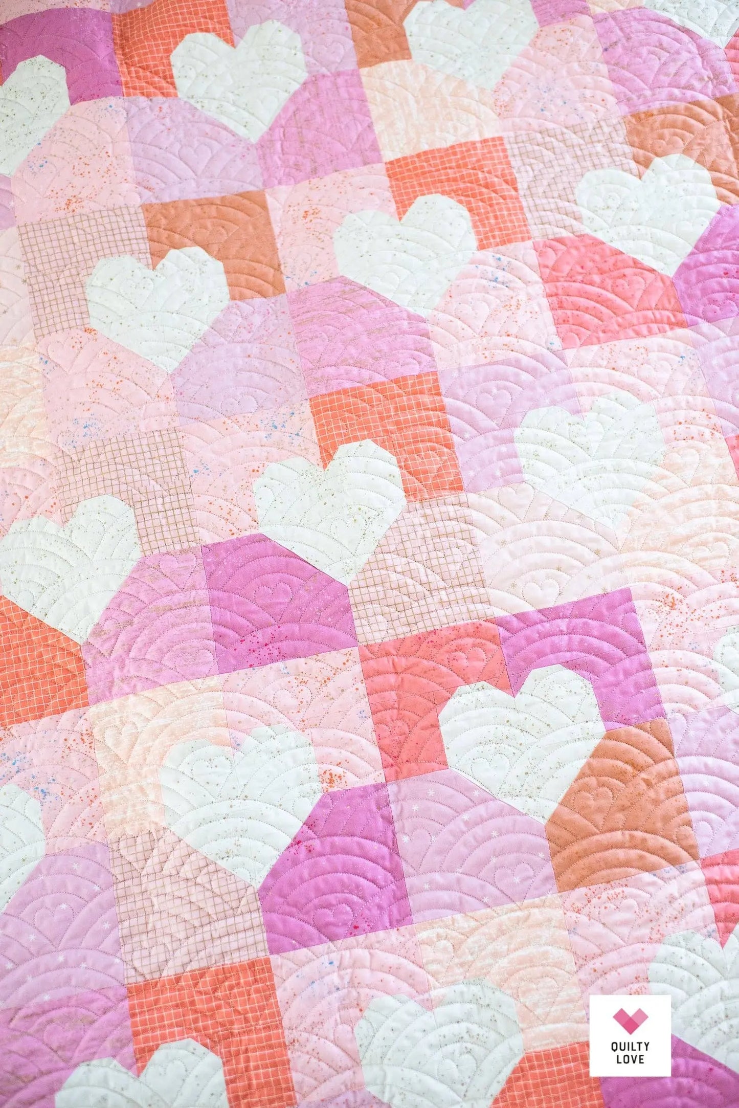 Quilt with heart patterns in pastel colors