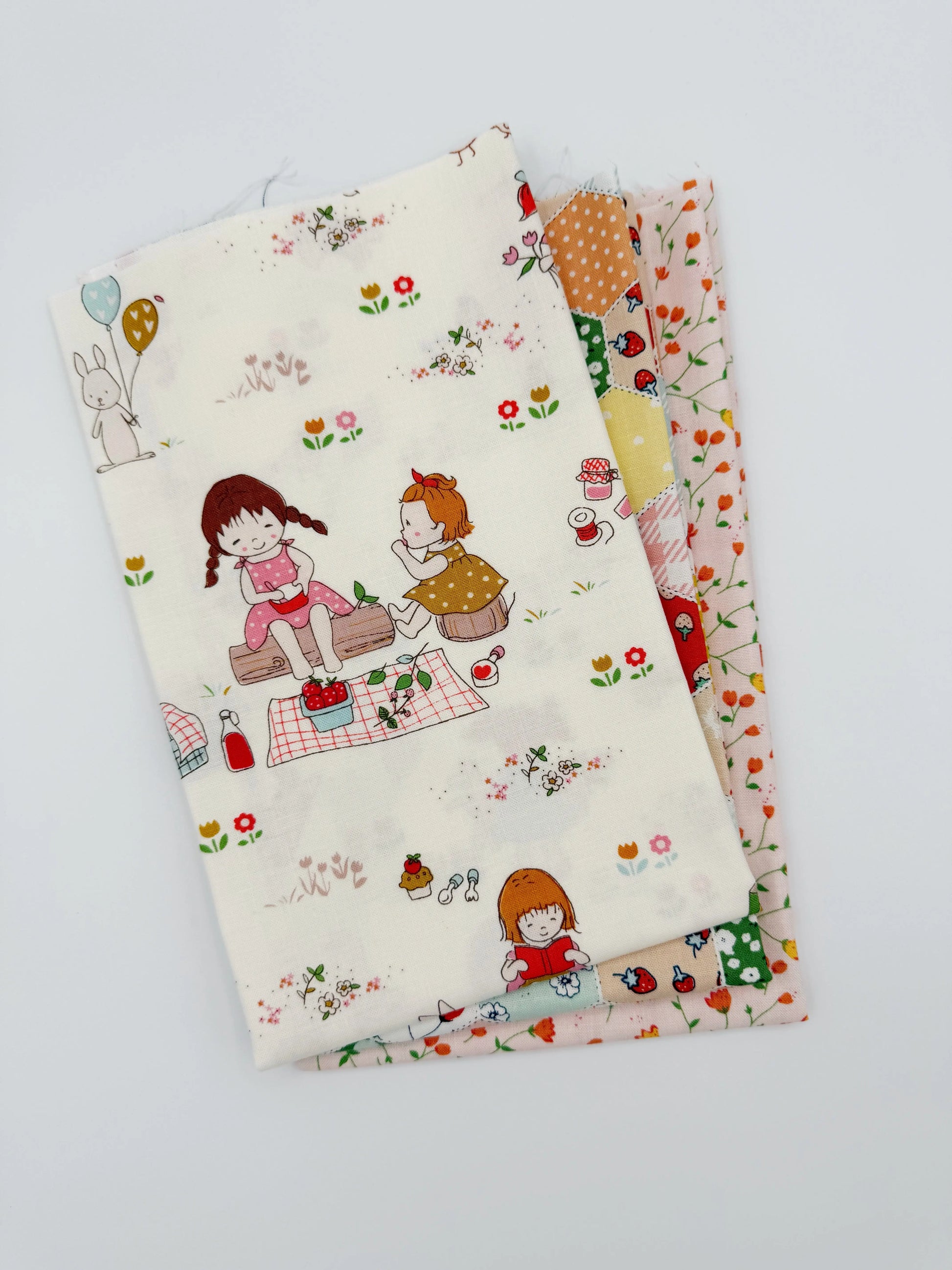 Three fabric swatches with cartoon designs on a white background