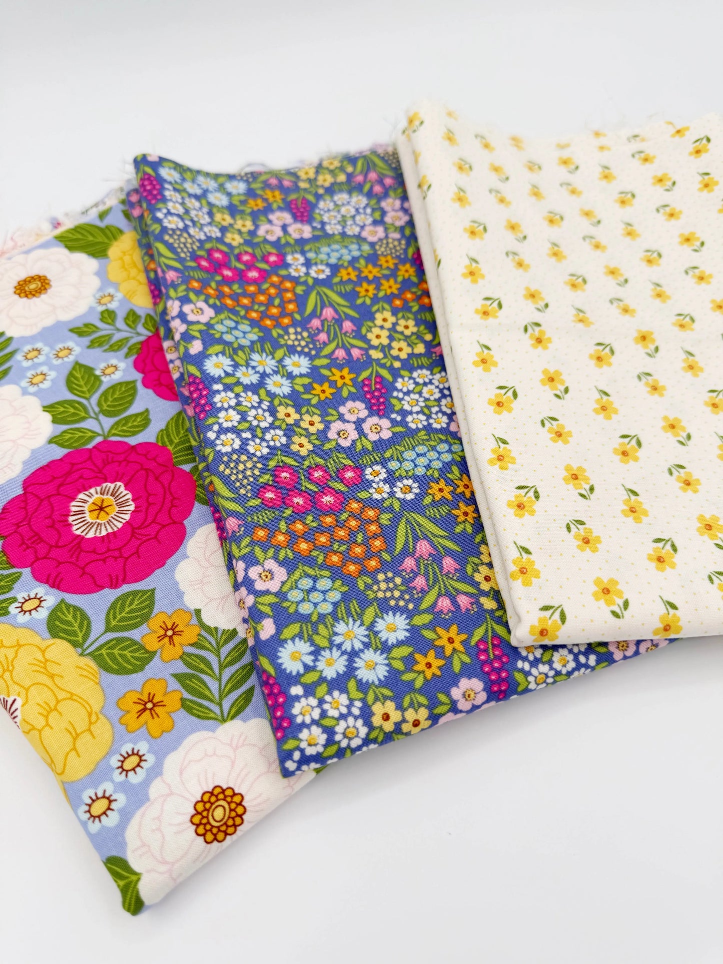 Three floral fabric swatches on a white background