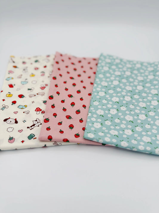 Three pieces of fabric with different patterns on a white background