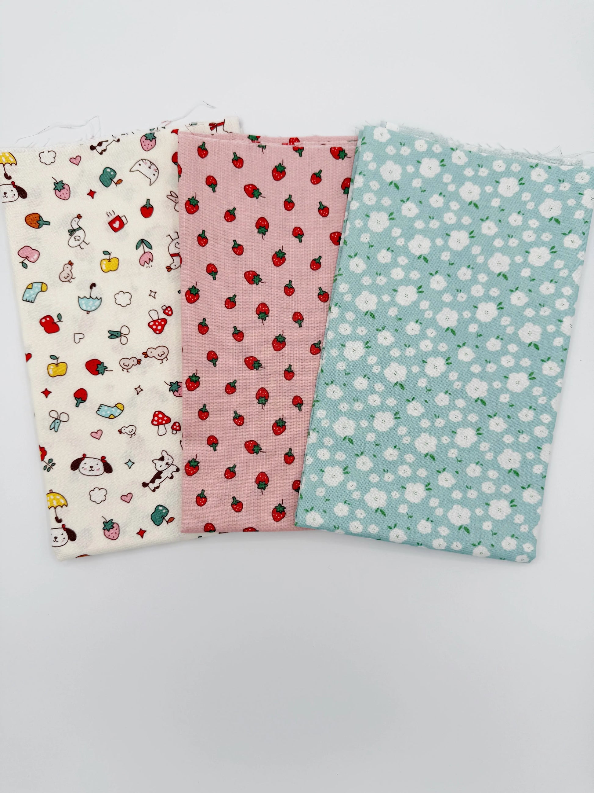 Three fabric swatches with different patterns on a white background