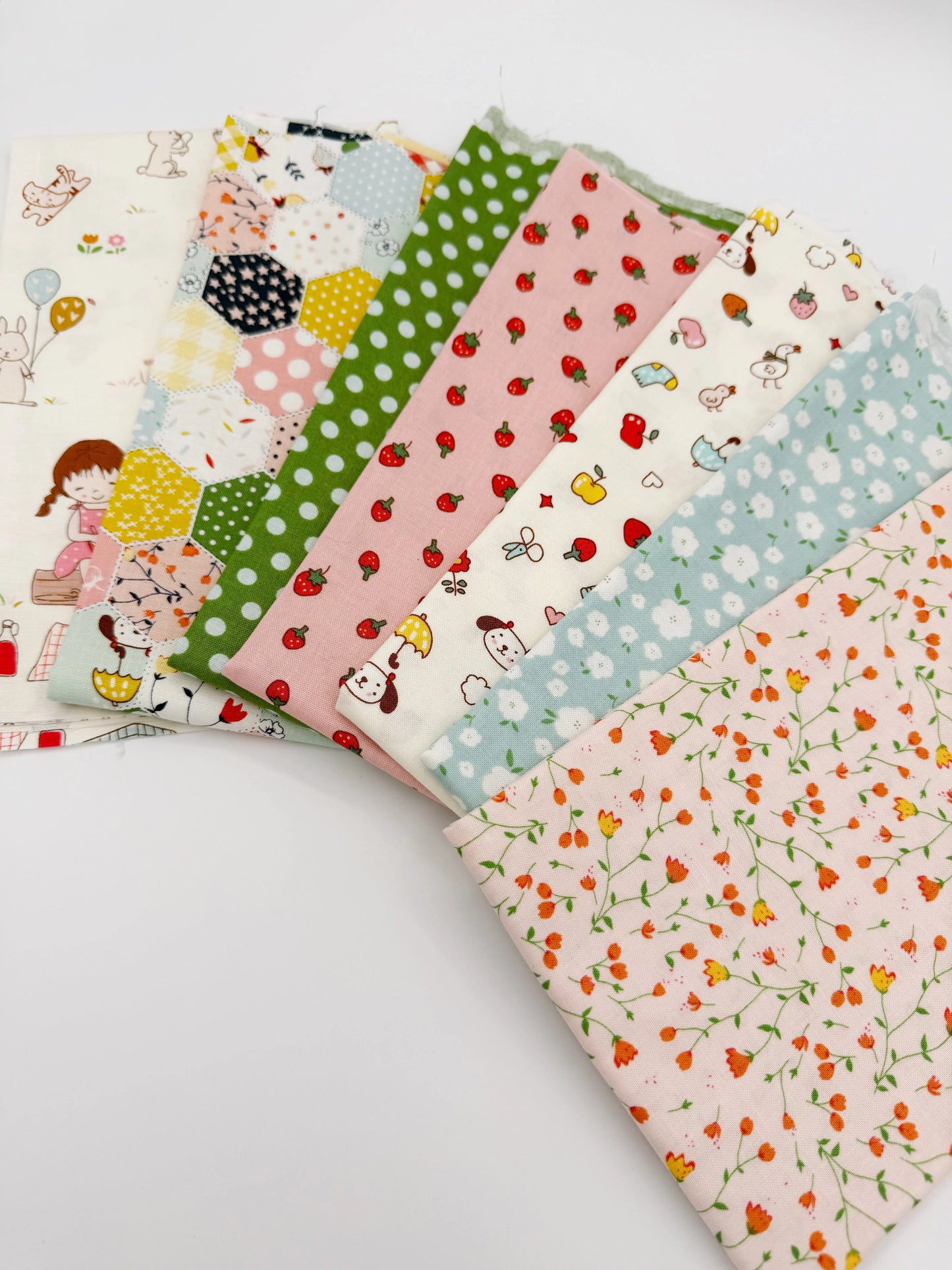 Collection of colorful fabric swatches with various patterns on a white background