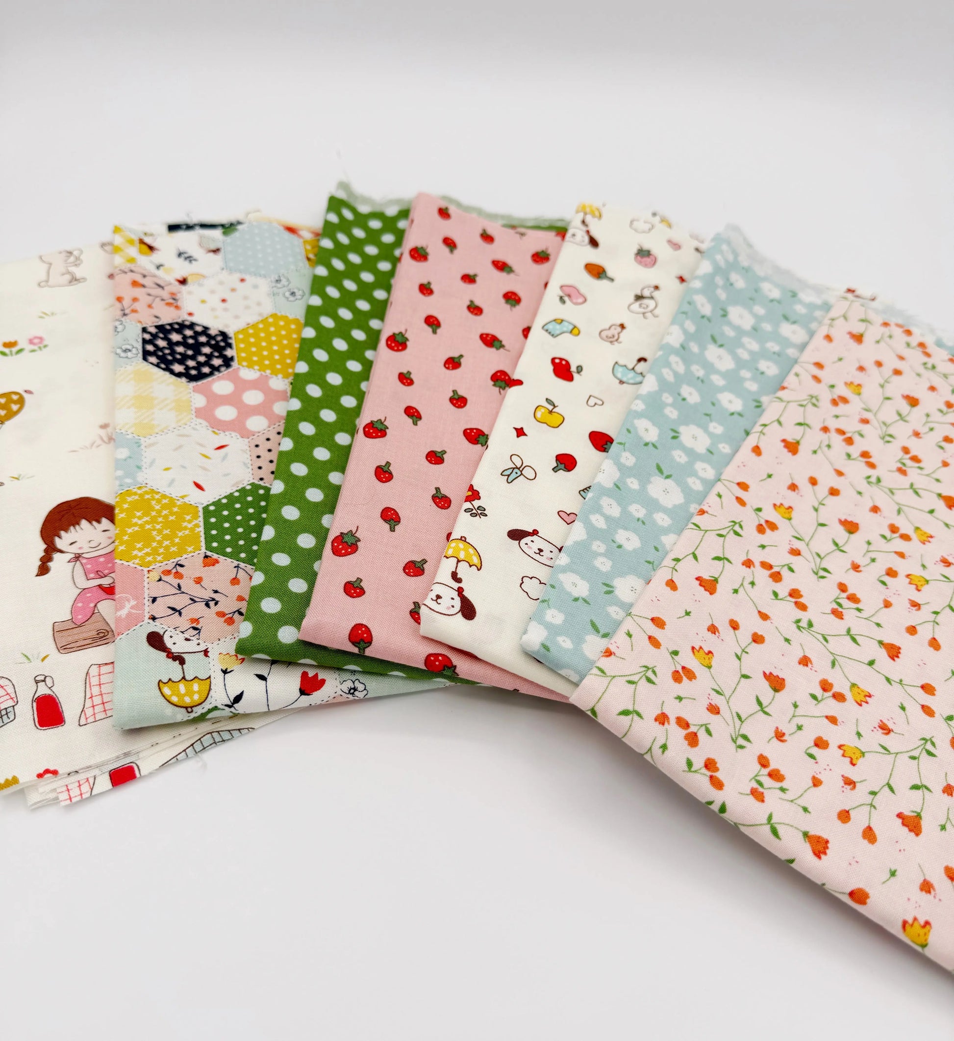 Set of colorful fabric swatches with various patterns on a white background