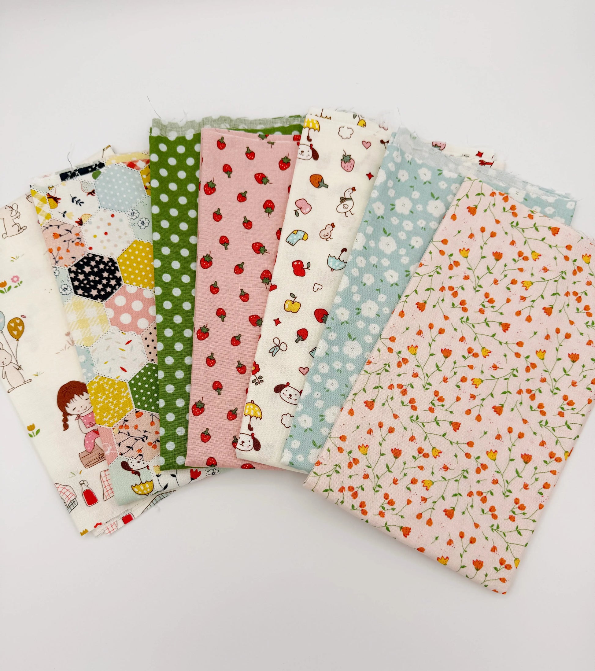 Set of colorful fabric swatches with various patterns on a white background