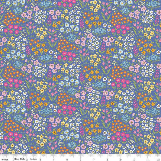 Colorful floral pattern on a periwinkle background with a fabric ruler at the bottom.