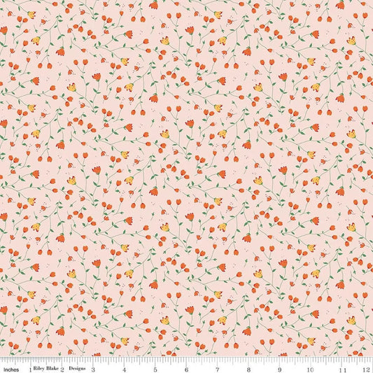 Floral pattern fabric with small orange and yellow flowers on a pink background