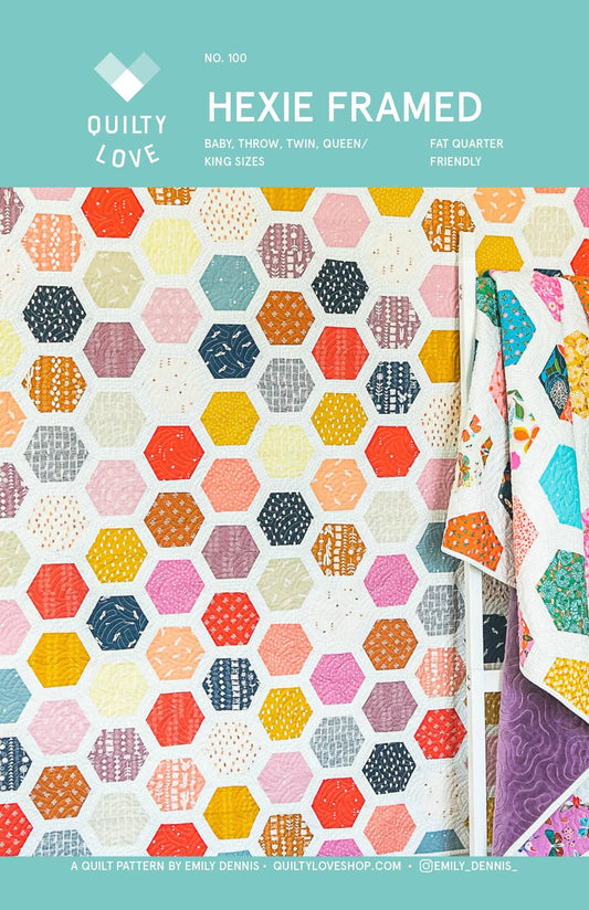 Hexie Framed quilt pattern by Quilty Love with colorful hexagonal patterns on a teal background.