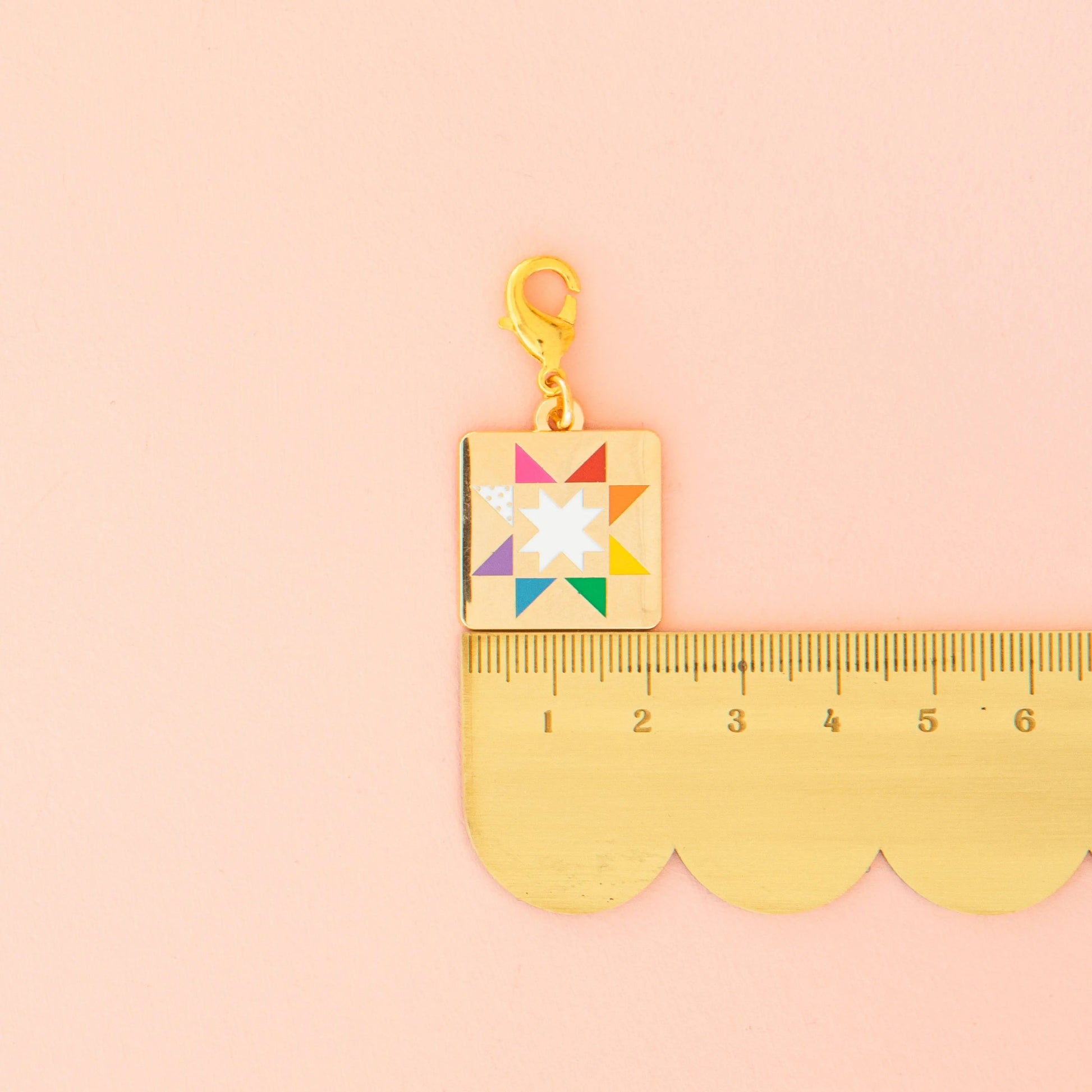 Colorful charm with a star design on a pink background