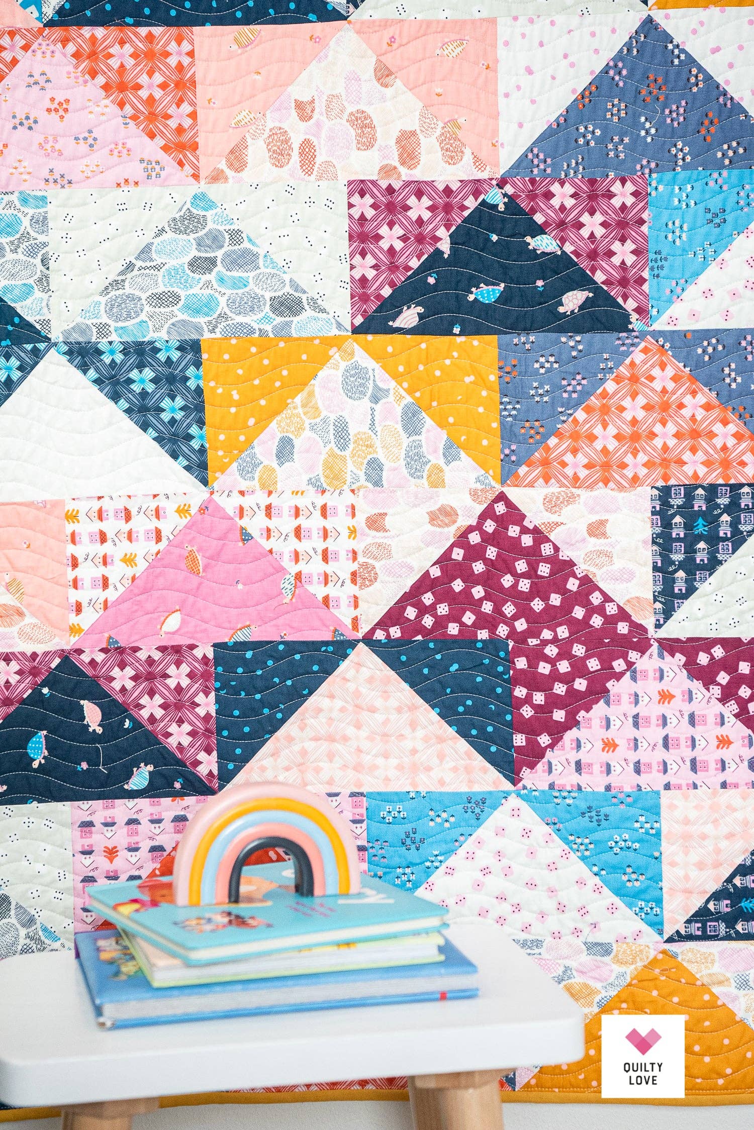 Colorful quilt with geometric patterns on a wooden surface