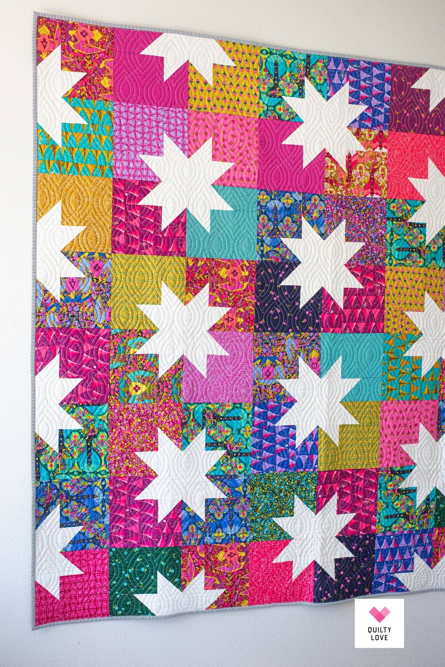 Colorful quilt with star patterns on a white background